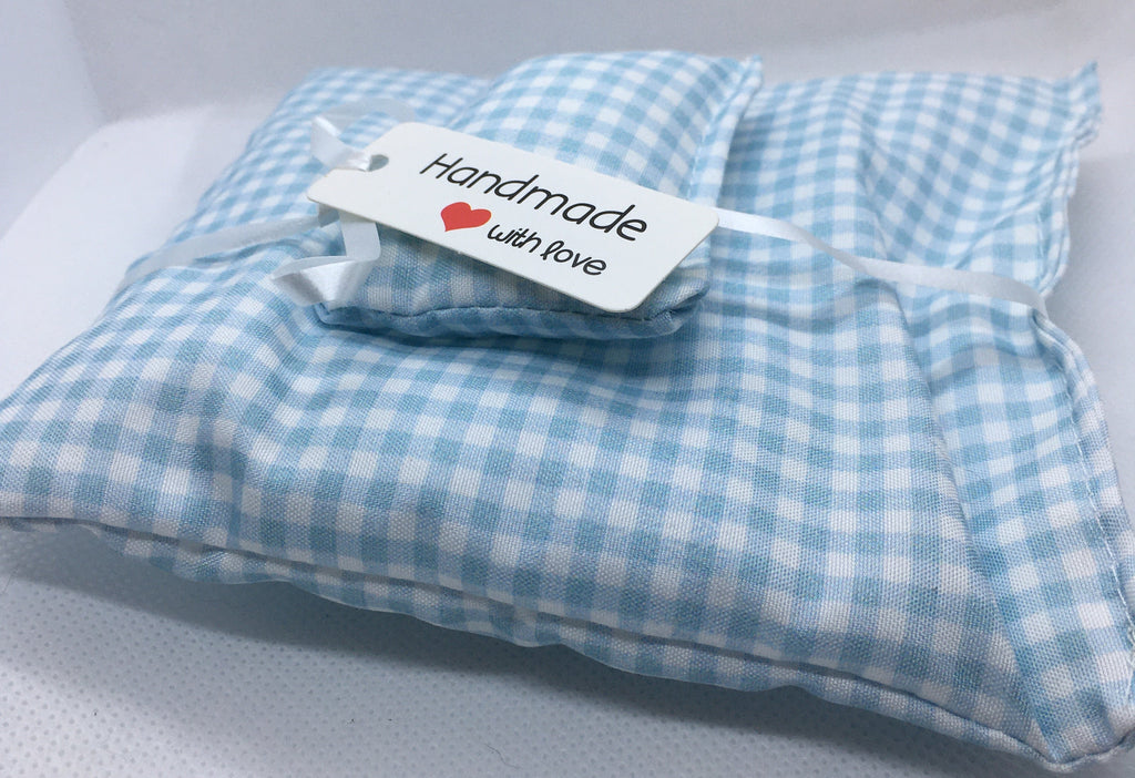 A light blue and white gingham check duvet set in miniature. wrapped with a white ribbon and a white paper tag that reads 'Handmade with love'.