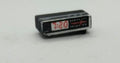 miniature clock radio in black with 7:20 on the digits. on a white background.