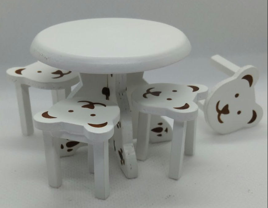 A small white table and four matching stools with bear face cutouts, shown on a plain light gray background.