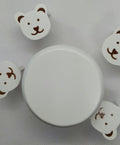 miniature table and stools for a dolls house nursery.  White with teddy bear shaped stools on a white background