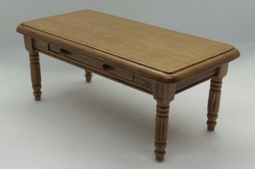 A miniature wooden coffee table with a light brown finish and turned legs, photographed on a neutral light gray background.